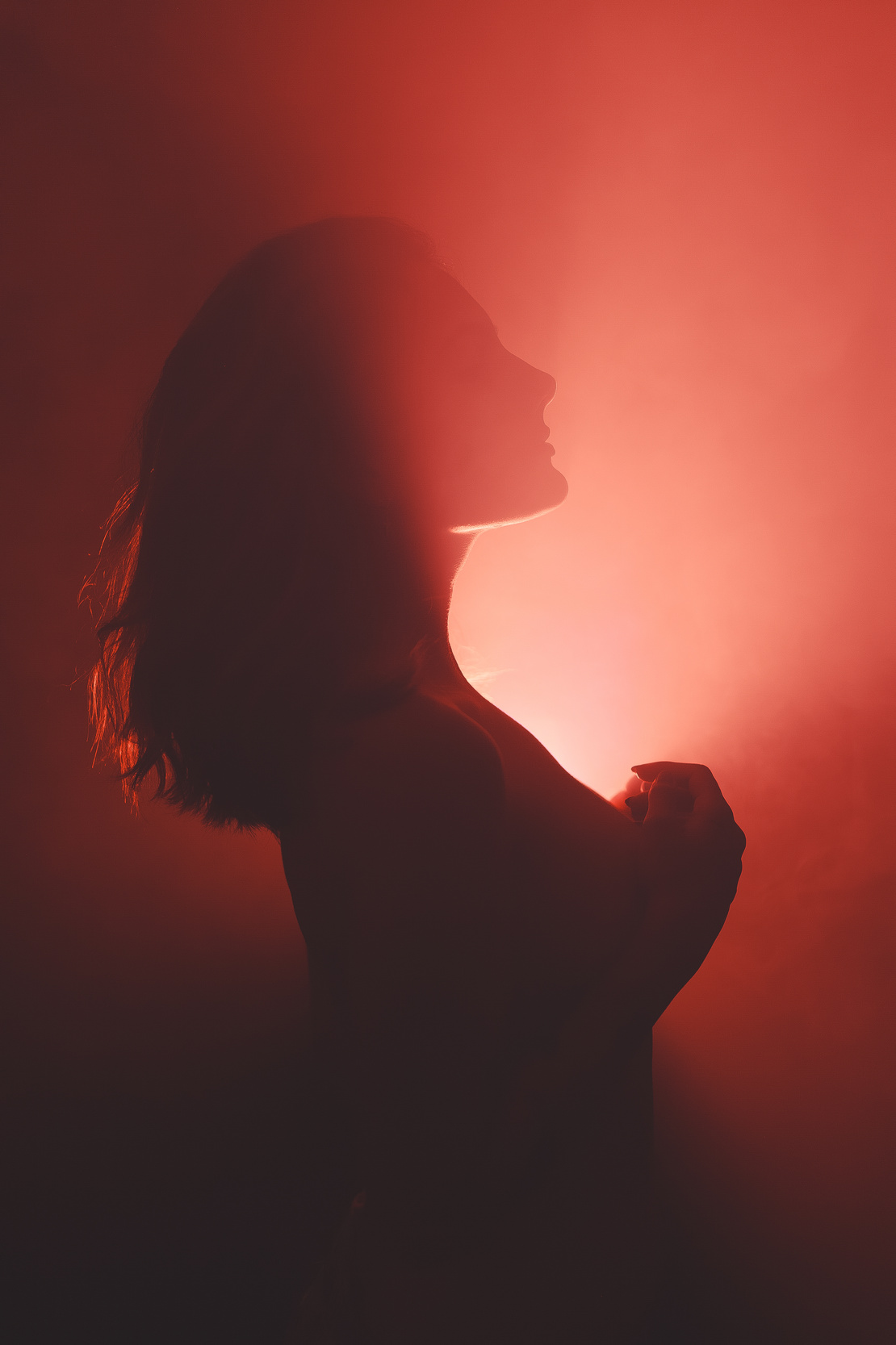 Woman in Red Light in the Dark